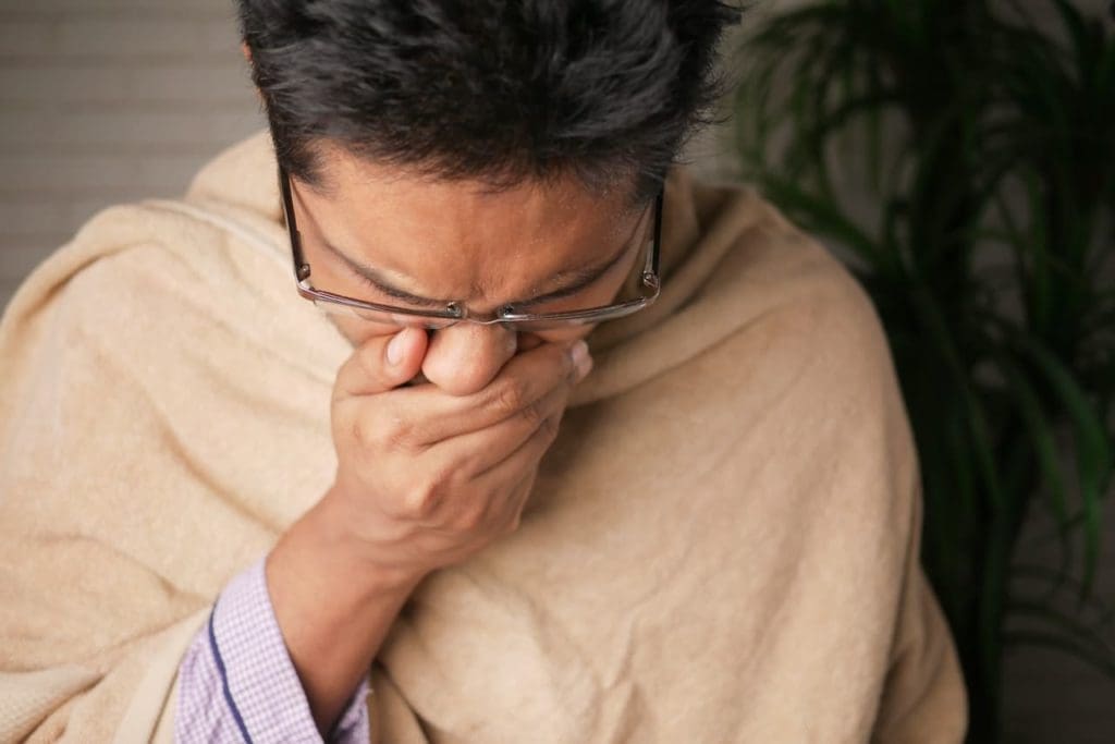 man sneezing to show what to ask app developers