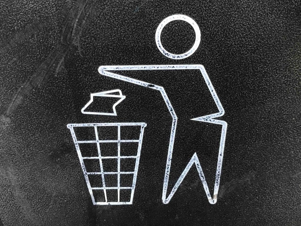 picture of man throwing app in rubbish bin to illustrate the importanc of listening to user needs