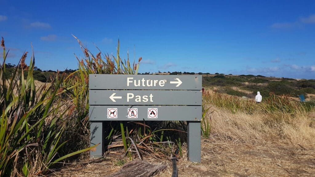 roadsign showing the future and the past direction