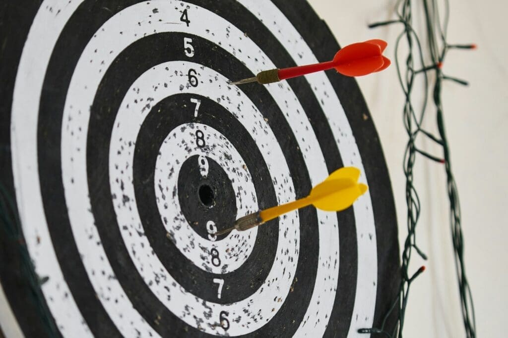 dartboard with darts close to centre showing how to get as accurate as possible when calculating roi on custom software costs and projected revenue