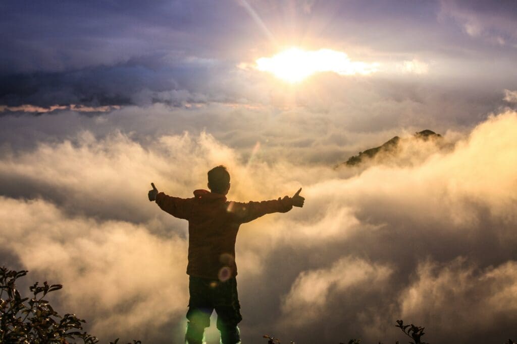 man standing above clouds as a humorous reference to mystery behind understanding app scalability for non techs