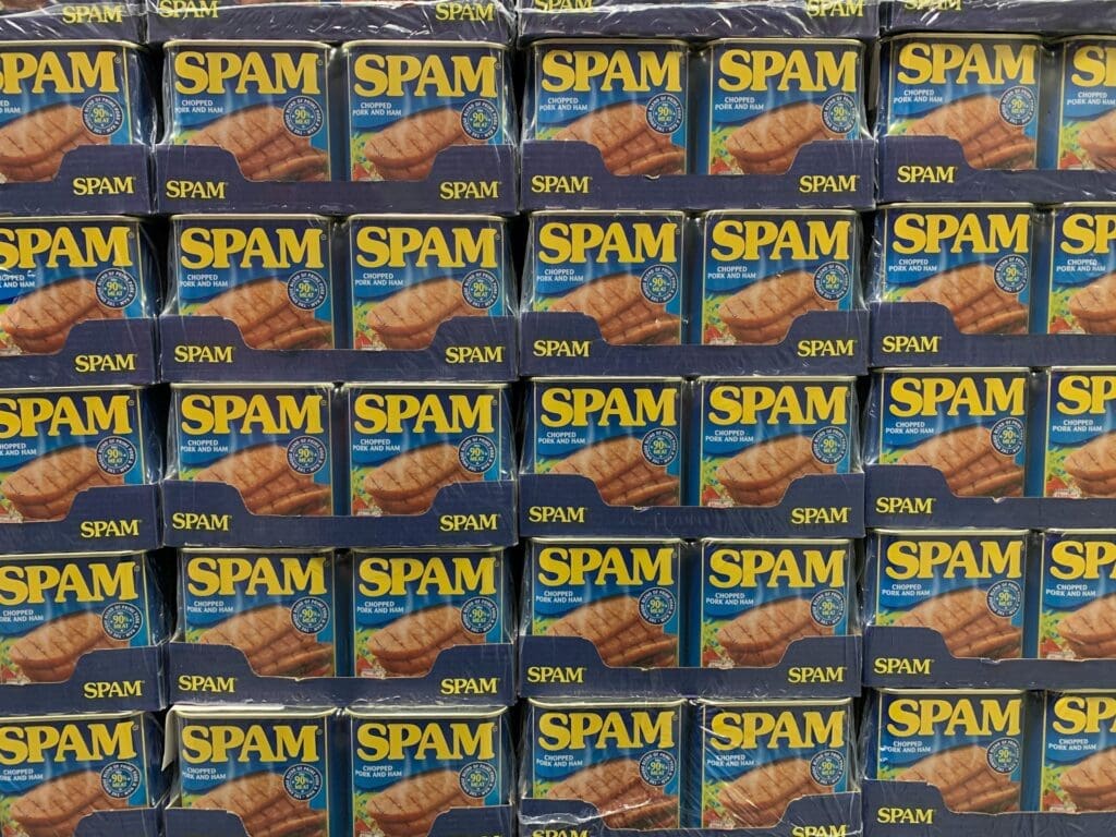 multiple cans of spam as a joke about how vibe coding tools use spammed ai prompts to build apps
